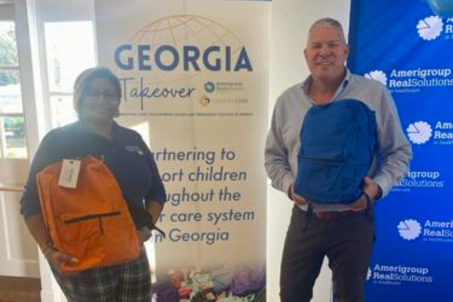 POSING AFTER A LONG DAY OF PACKING: Rob Scheer and Bhavini Solanki hold up two Comfort Cases that were packed on Thursday at Vashti Center.