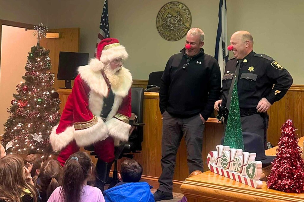 Pictured, from left, are Santa Claus and his two red-nosed reindeers, Upshur County Commissioner Sam Nolte and Upshur County Sheriff Mike Coffman at Monday's party. / (Submitted photo)